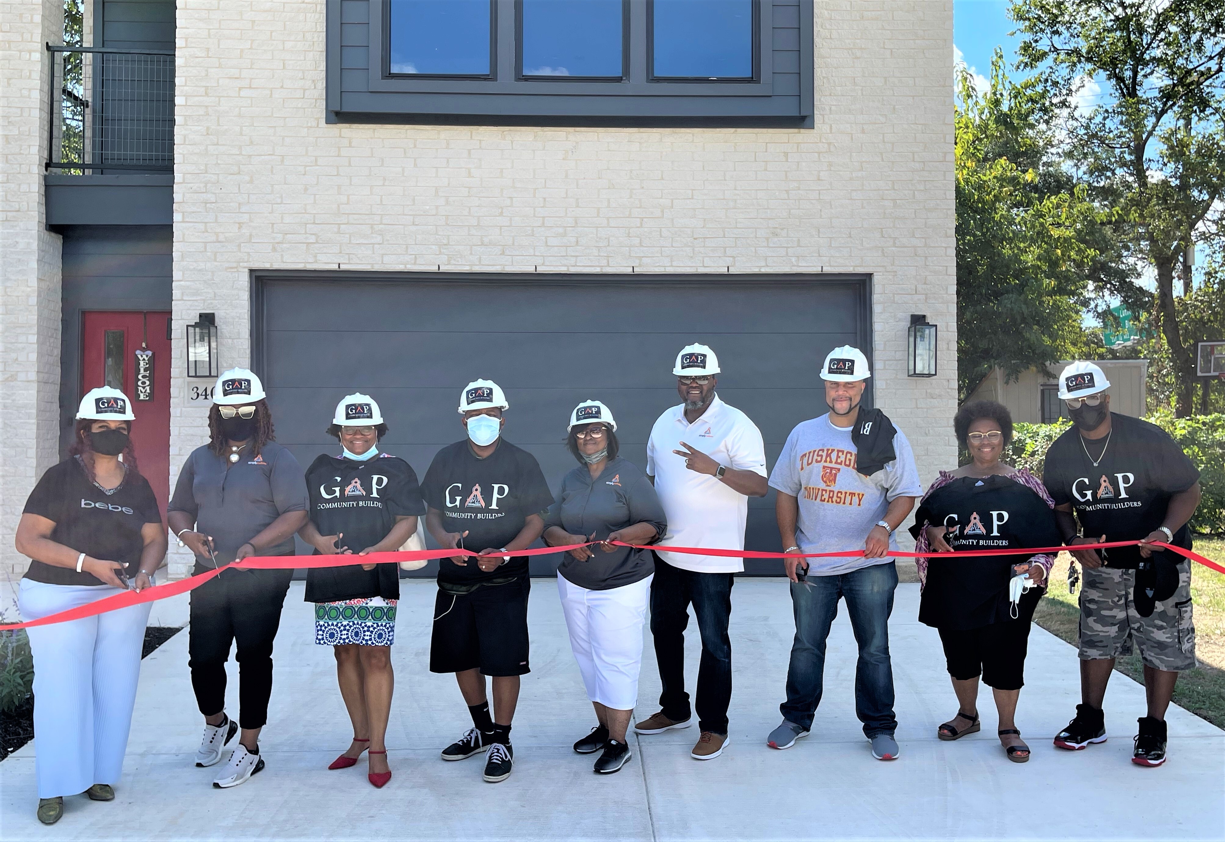 Simply Custom leadership and GAP Community Builders at a ribbon-cutting with community members
